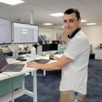 Photo of Patrick at his standing desk